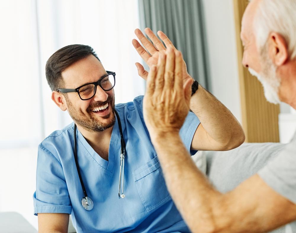 A nurse giving a patient a high five